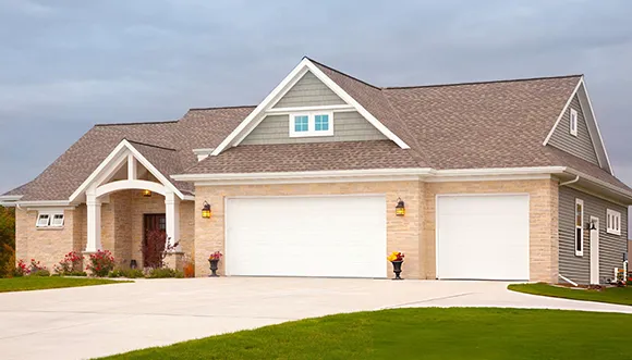 Front view of a single-story house with a double garage and well-maintained lawn, illustrating cash home buying services in Nampa, ID.