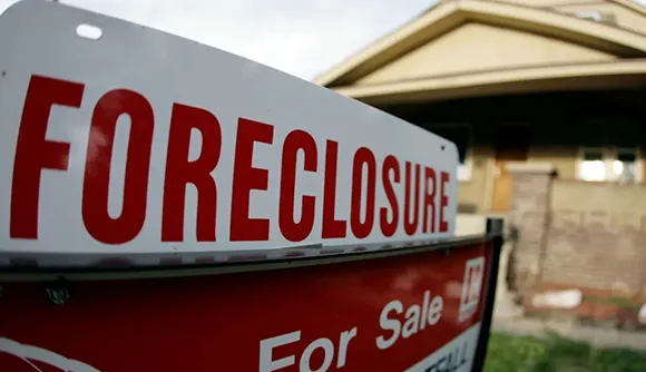 House with a 'Foreclosure' sign in the yard, representing foreclosure cash buyers in Spokane, WA.