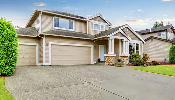 Front view of a single-story house with a double garage and well-maintained landscaping, illustrating cash home offers in Spokane, WA.